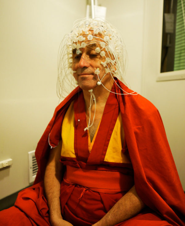 Monk Matthieu Ricard meditates with EEG on scalp by Jeff Miller